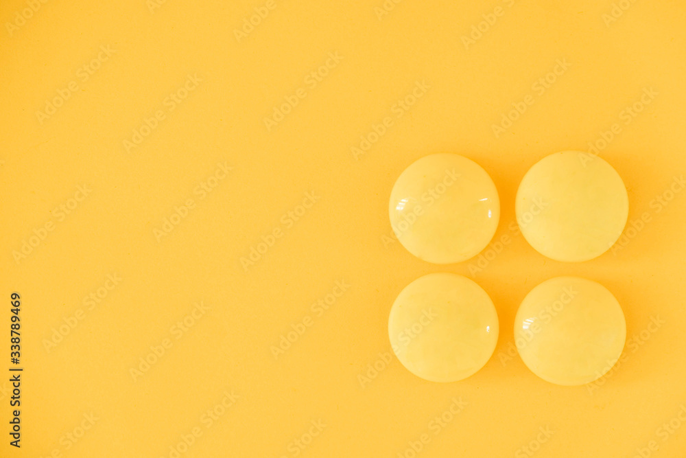 Yellow balls on yellow background. Minimal concept. Top view. Copy, empty space for text Yellow balls on yellow background. Minimal concept. Top view. Copy, empty space for text