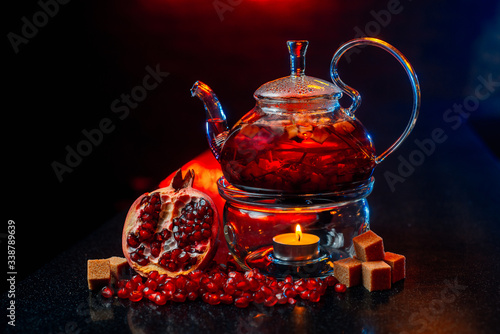 Natural tea. Pour boiling water in a glass teapot, the ingredients are nearby