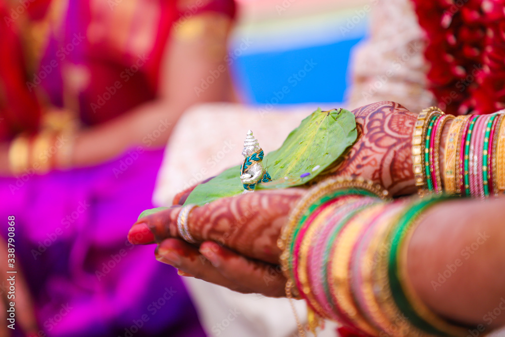 Traditional indian wedding ceremony, groom holding bride hand
