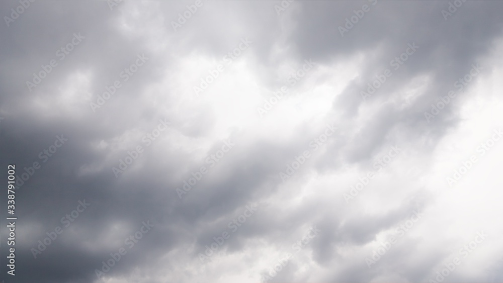 Dramatic gray and white clouds in the sky. Beautiful dark sky, 16:9 panoramic format Dramatic gray and white clouds in the sky. Beautiful dark sky, 16:9 panoramic format