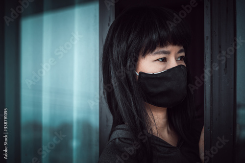 Asian woman wearing a black...