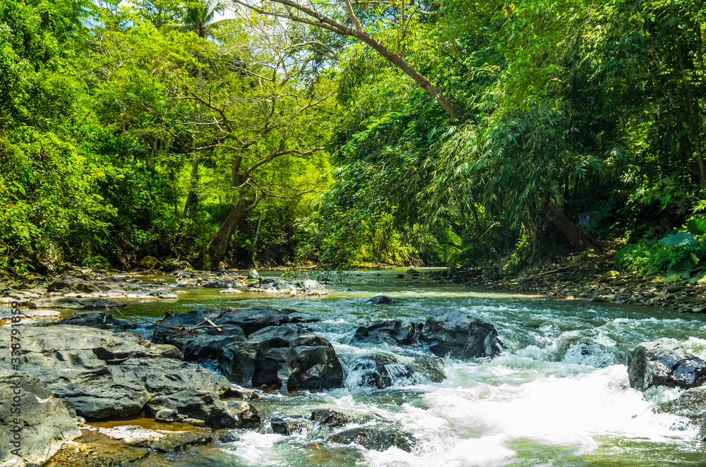 View on mountain river on Tegenungan waterfall on Bali View on mountain river on Tegenungan waterfall on Bali