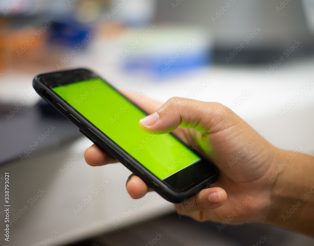 Hand holding smart phone green screen. Hand holding smart phone green screen.
