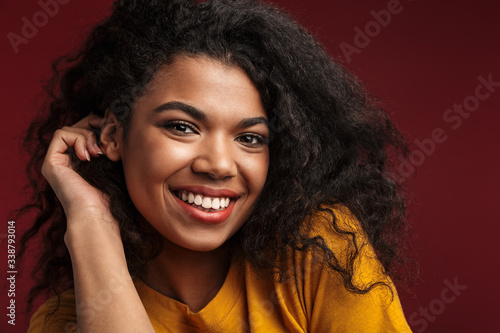 Image of beautiful brunette african american woman with curly hair smiling © Drobot Dean