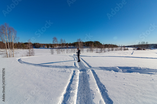 A man stands in the snow in a finnish landscape