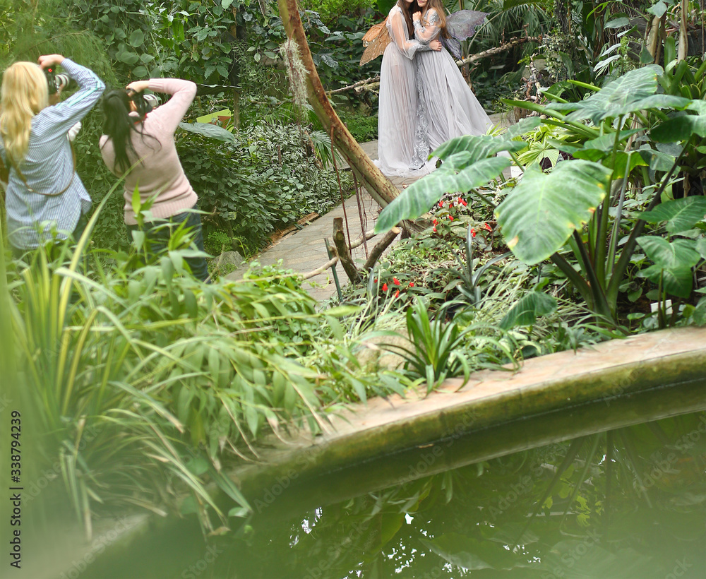 Backstage from a fairy tale shoot with two magic elves in a botanical ...
