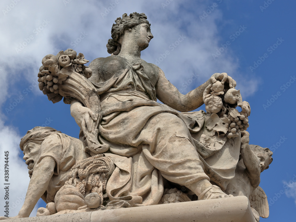 Antique statue in the park of Versailles palace near Paris, France Antique statue in the park of Versailles palace near Paris, France