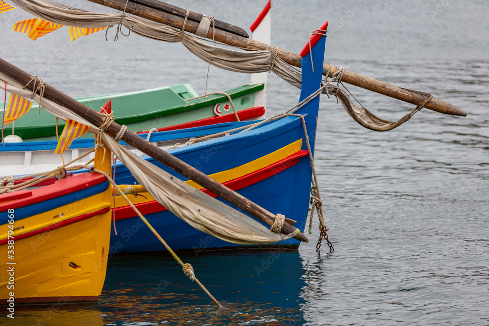 Detail of some multi colored wooden boats on the sea in a town of France Detail of some multi colored wooden boats on the sea in a town of France