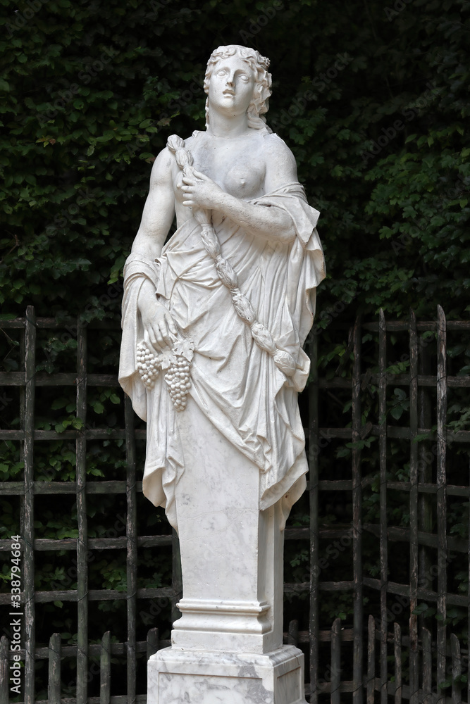 Antique statue in the park of Versailles palace near Paris, France Antique statue in the park of Versailles palace near Paris, France