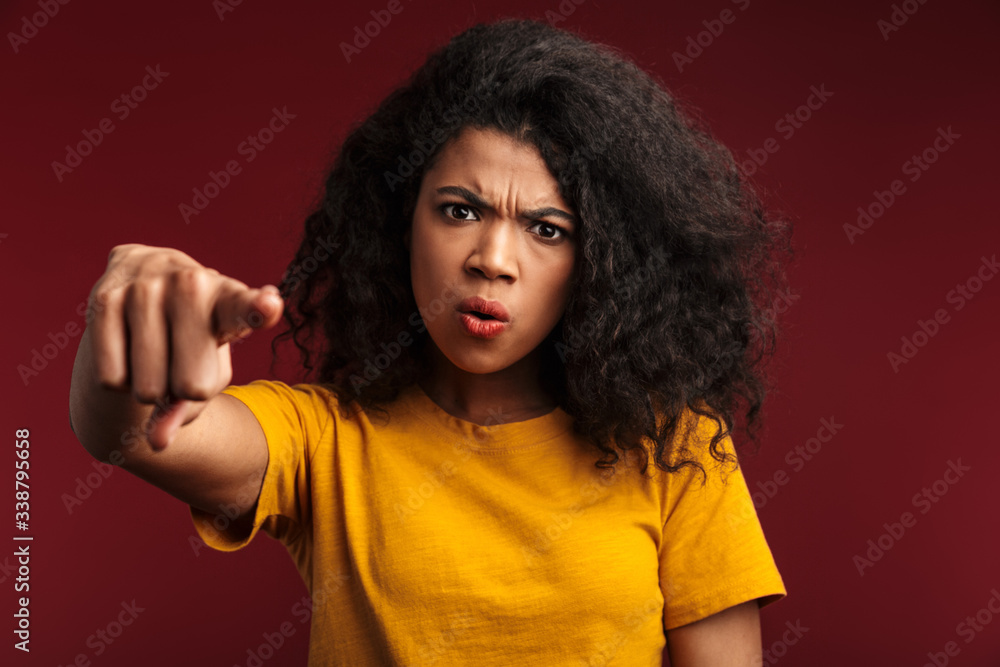 Image of disappointed african american woman pointing finger at you Image of disappointed african american woman pointing finger at you