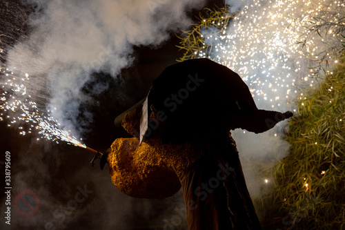 Photography Head of the firework beast of Molins de Rei Town Festival while throwing sparks