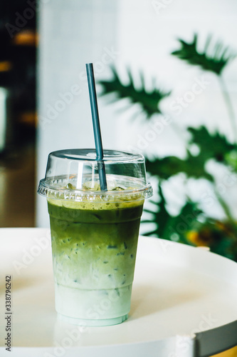 Iced green tea in takeaway cup in coffee shop 