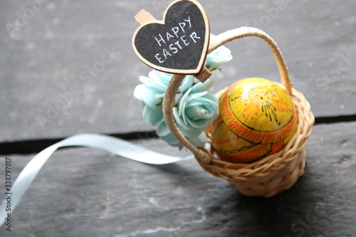 Happy easter card. Wicker basket with easter egg. Spring easter background with space for text. Vintage style.