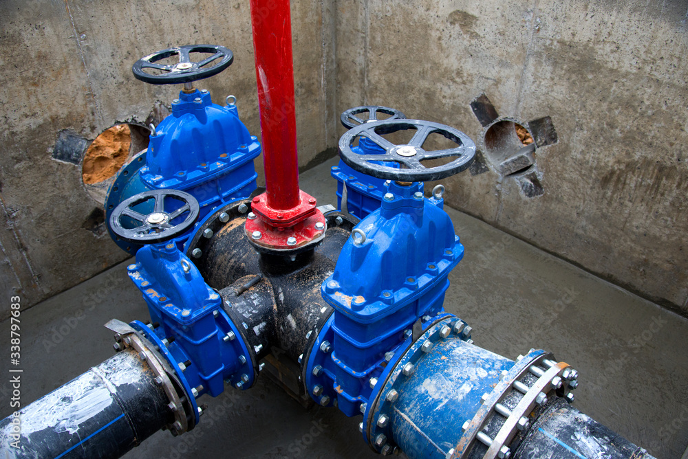 Gate valves in valve pit of the underground piping networks. Laying water  system pipeline at construction site. Water supply pipeline, pipes in  trench. Sewage pumping stations, stormwater, utilities Photos | Adobe Stock