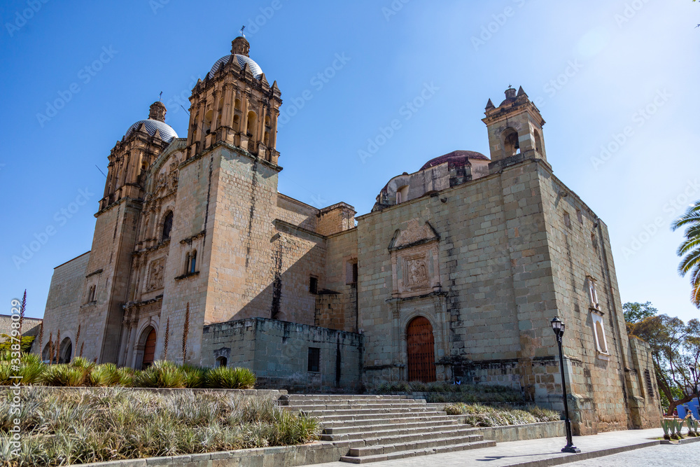 Sideview of the Santo Dominog church of Oaxaca de Juárez, in Mexico, with a morning sunlight and a clear sky.