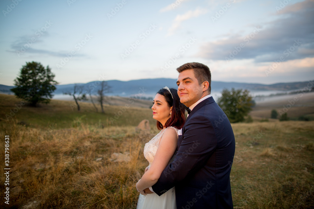 Beautiful wedding couple posing outdoor in park Beautiful wedding couple posing outdoor in park