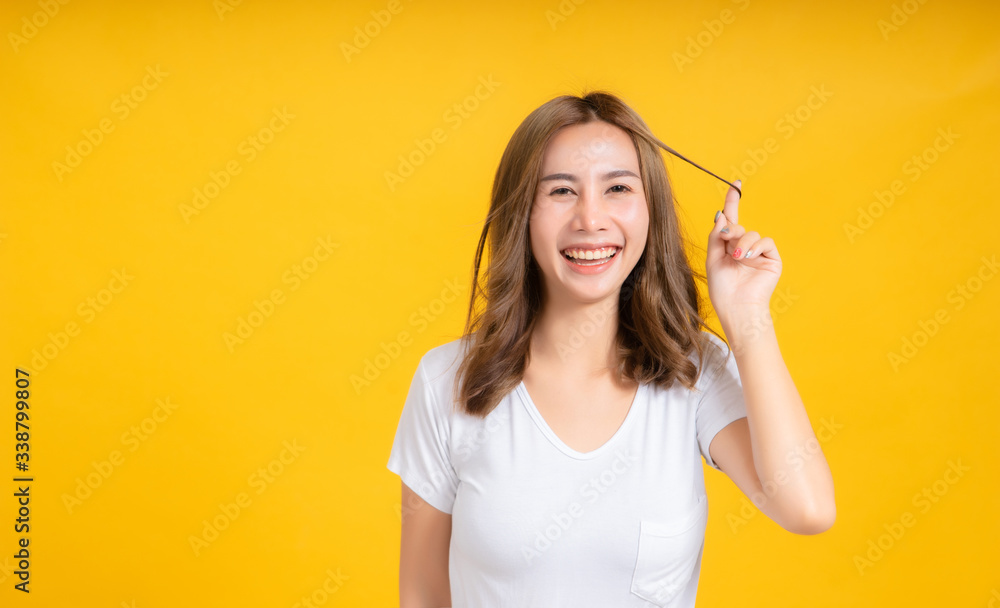 Portrait happy young asian woman feeling carefree laughing positive emotion in white t-shirt, Yellow background isolated studio shot and copy space. Portrait happy young asian woman feeling carefree laughing positive emotion in white t-shirt, Yellow background isolated studio shot and copy space.