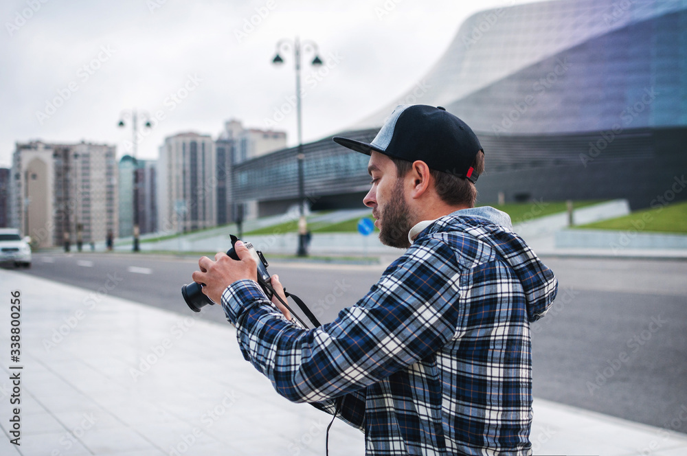 Young man traveler takes images with dslr camera in the city Young man traveler takes images with dslr camera in the city
