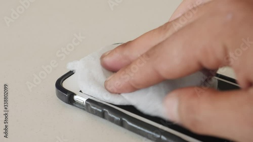 close up of a hand holding cleaning a Iphone