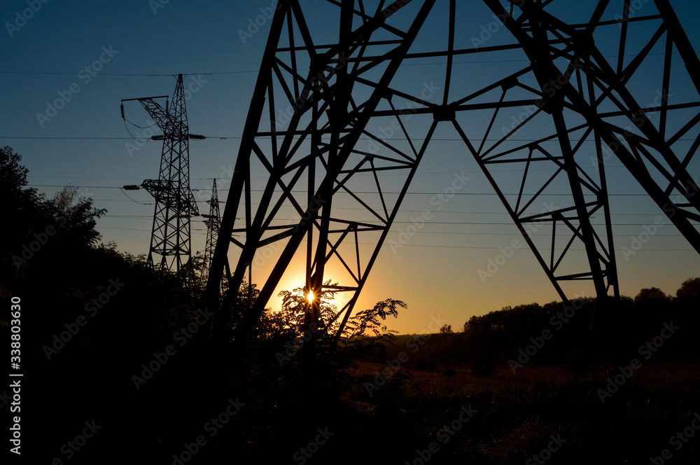 transmission lines tower in sunset