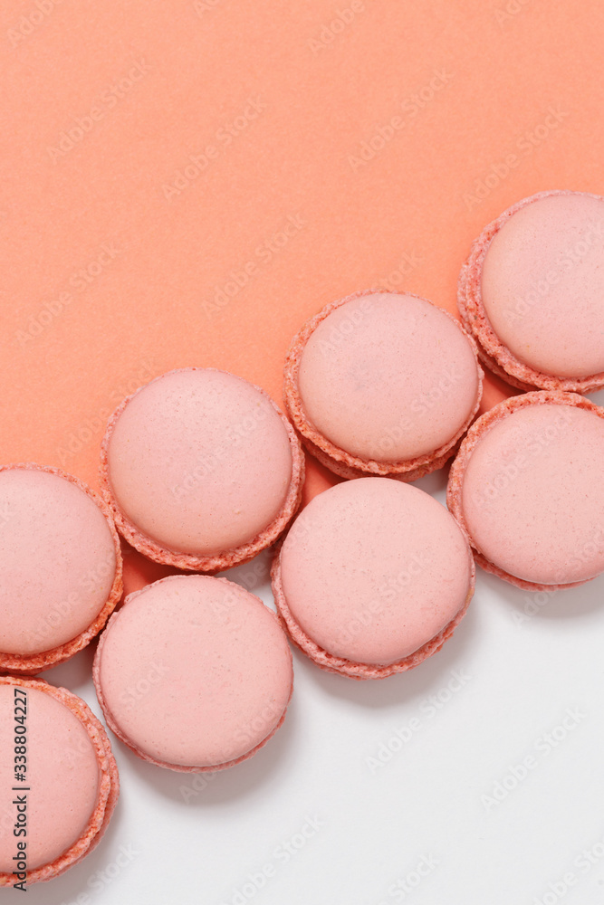 Row of macaroons on colorful background with copy space. Orange tasty round cookies. Minimal style. Row of macaroons on colorful background with copy space. Orange tasty round cookies. Minimal style.