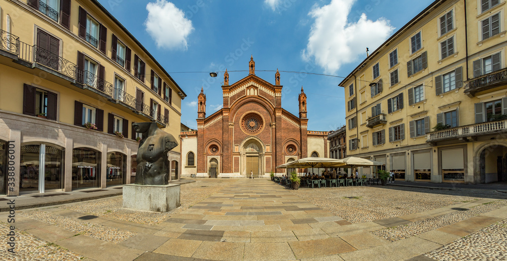 MILAN, ITALY - AUGUST 01, 2019: Santa Maria del Carmine Church. Tourists and locals walk in the center of Milano. Shops, boutiques, cafes and restaurants. Super wide angle panorama