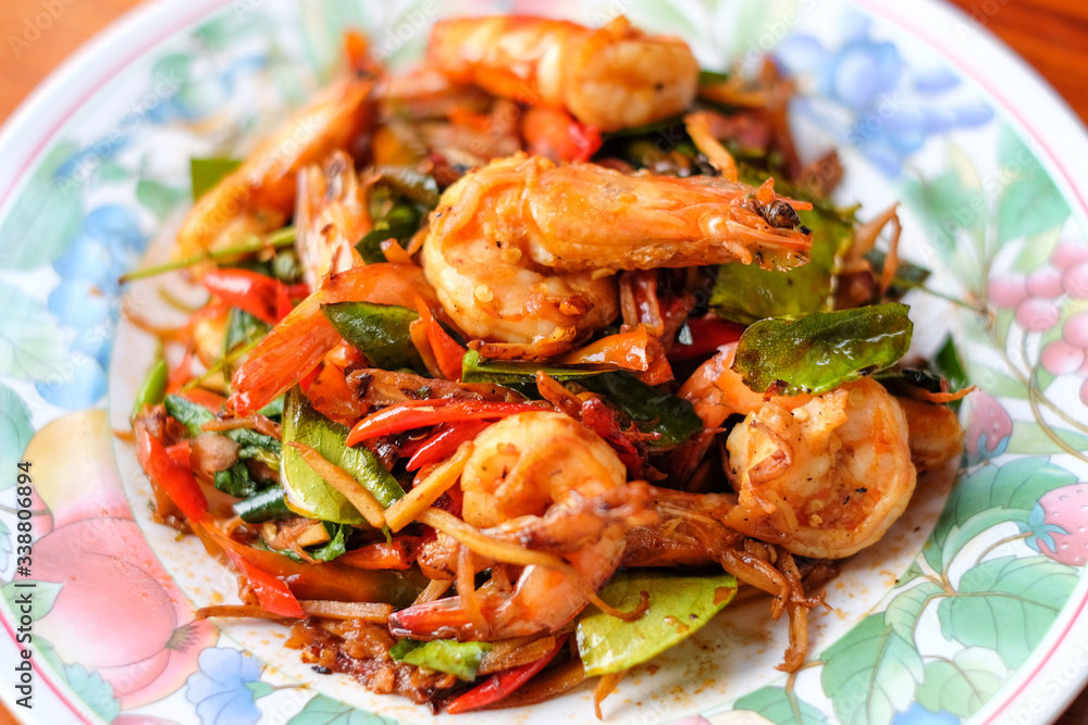 The hot fried stir spicy giant shrimp serve on dish.