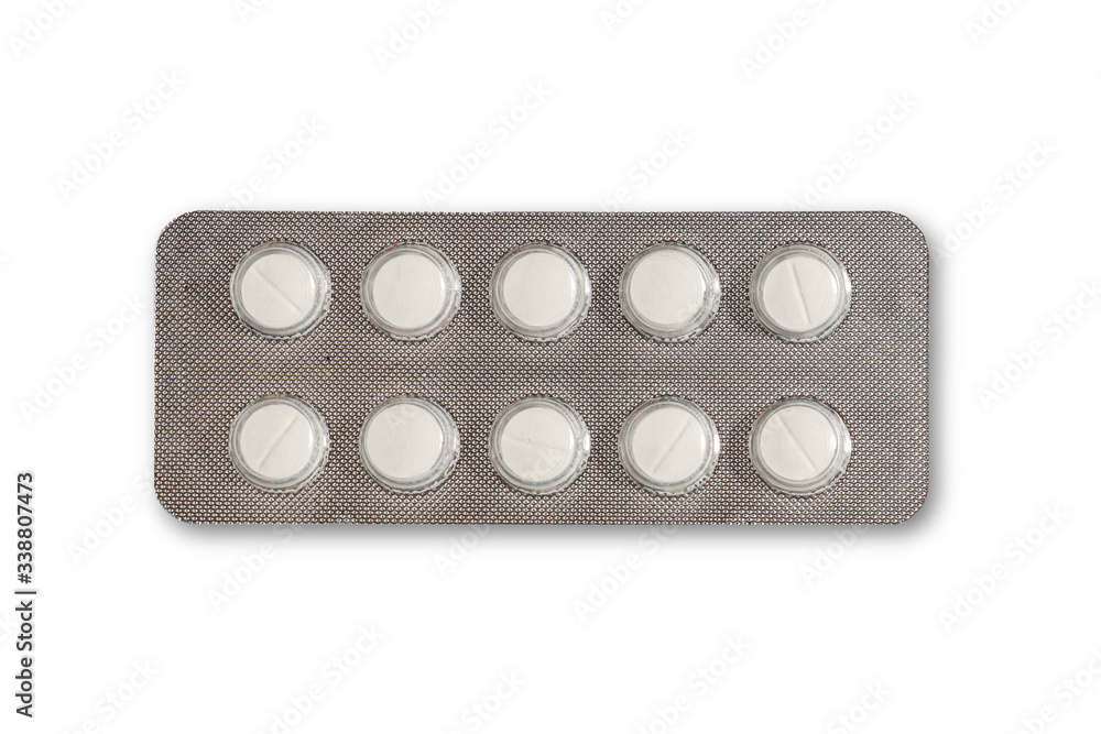 White pills in the silver medicine panel on a white background White pills in the silver medicine panel on a white background