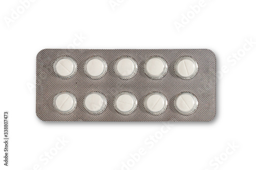 White pills in the silver medicine panel on a white background