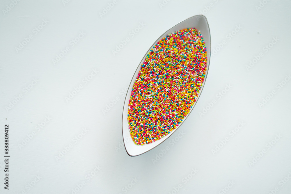Colourful Sugar sprinkles, decoration for cake, ice-cream and cookies. Top view, Flat lay on white background. Copy space. Colourful Sugar sprinkles, decoration for cake, ice-cream and cookies. Top view, Flat lay on white background. Copy space.