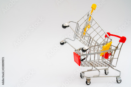 Metal trolley for supermarket. Transportation of products in store. Retail.