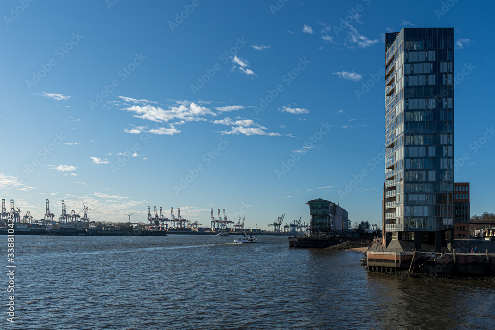 Naklejka premium Hamburg container port with some ships loading and cranes transporting container to the freighters