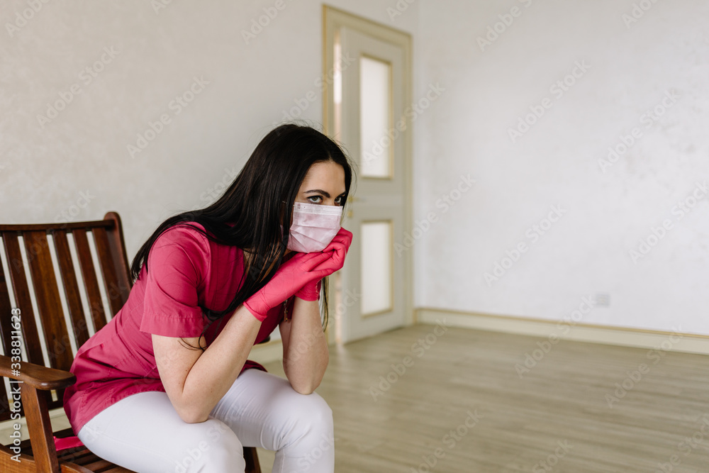 female doctor in medical mask sitting after hard work day female doctor in medical mask sitting after hard work day