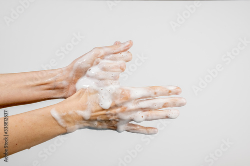 Caucasian woman washing her hands isolated on white background