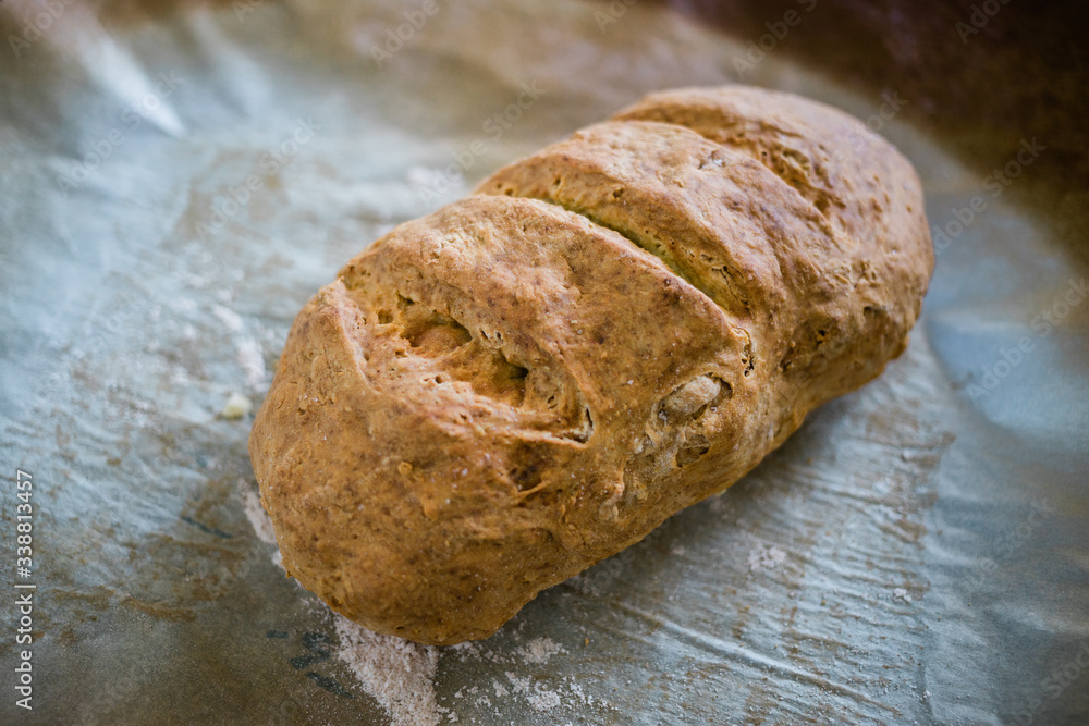 Close-up of a fresh homemade bread on baking paper 