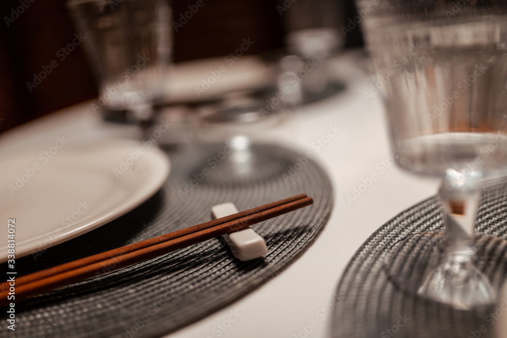 Table setting in a chinese restaurant. Close-up of Chinese chopsticks on a table Table setting in a chinese restaurant. Close-up of Chinese chopsticks on a table