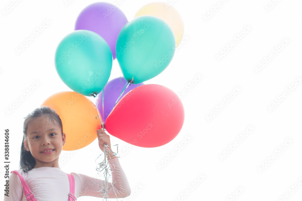 Obraz premium happy little asian girl child playing with colorful toy balloons outdoors. summer holidays, celebration, family, children and people-happy girl with colorful balloons. freedom and imagination concept.
