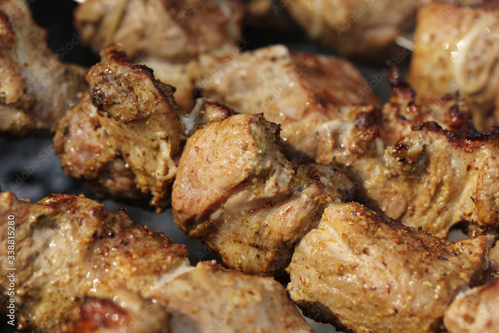 Pork shashlik kebab is fried on the grill on coals on skewers on the dacha. Background image, copy space Pork shashlik kebab is fried on the grill on coals on skewers on the dacha. Background image, copy space