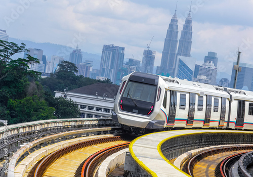 Photography Malaysia Mass Rapid Transit (MRT) train with a background of Kuala Lumpur cityscape