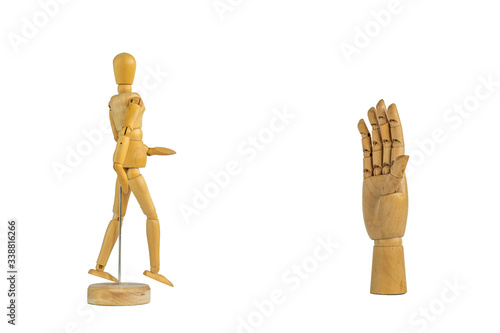 Wooden hand signalling stop and mannequin isolated on white background - social distancing concept