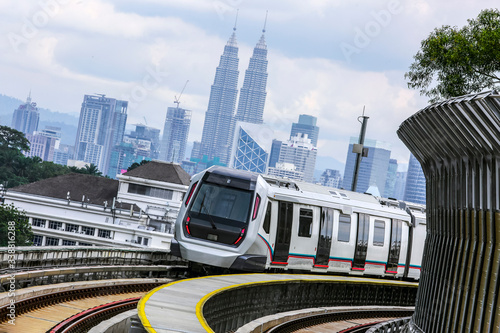 Photography Malaysia Mass Rapid Transit (MRT) train with a background of Kuala Lumpur cityscape