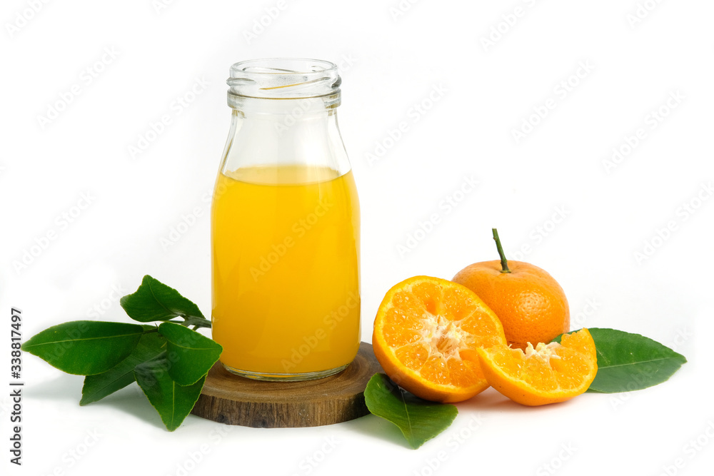 Fresh orange juice above wood coaster, with raw, sliced orange fruit – isolated on white background Fresh orange juice above wood coaster, with raw, sliced orange fruit – isolated on white background