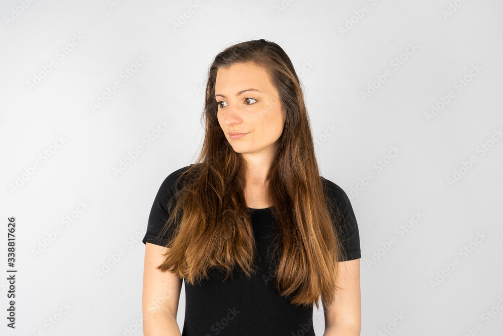 Young woman thinking or sobbing in black shirt with long hair Young woman thinking or sobbing in black shirt with long hair