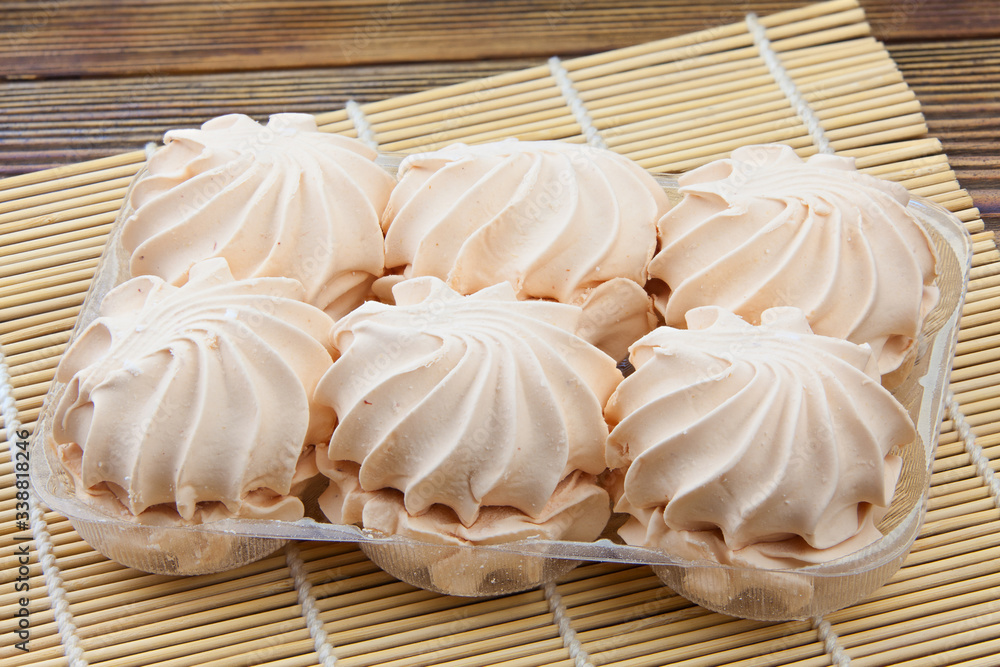 Delicious white vanilla marshmallow on plate on wooden background Delicious white vanilla marshmallow on plate on wooden background