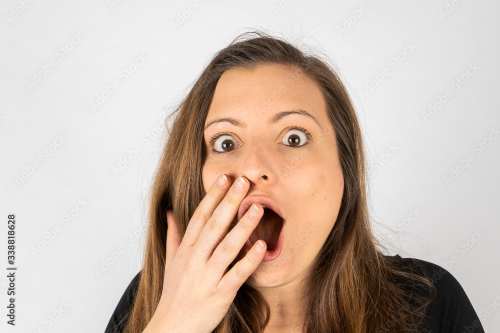 Young woman surprised in black shirt with long hair Young woman surprised in black shirt with long hair