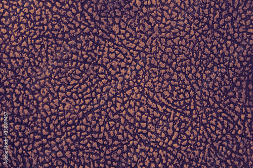 Old red dermatin. Close-up. Selective focus. Background. Texture.