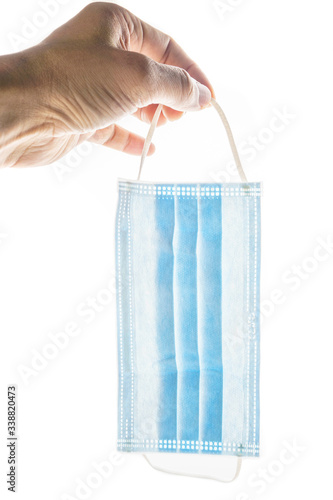 hand holding face mask isolated white.vertical shot.