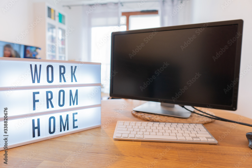 Working from home remote work inspirational social media lightbox message board next to monitor, COVID-19 quarantine closure of all Working from home remote work inspirational social media lightbox message board next to monitor, COVID-19 quarantine closure of all