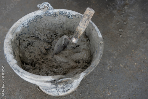 Plastering trowel mixed cement in a bucket