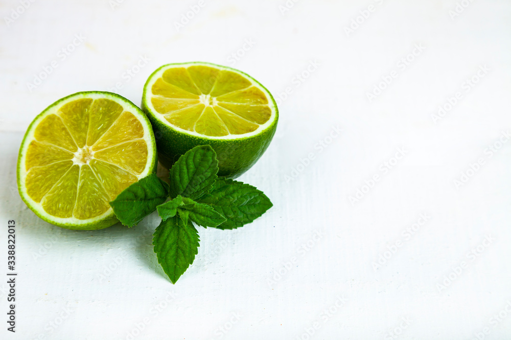 Lime and mint on a blue wooden table. Lime and mint on a blue wooden table.